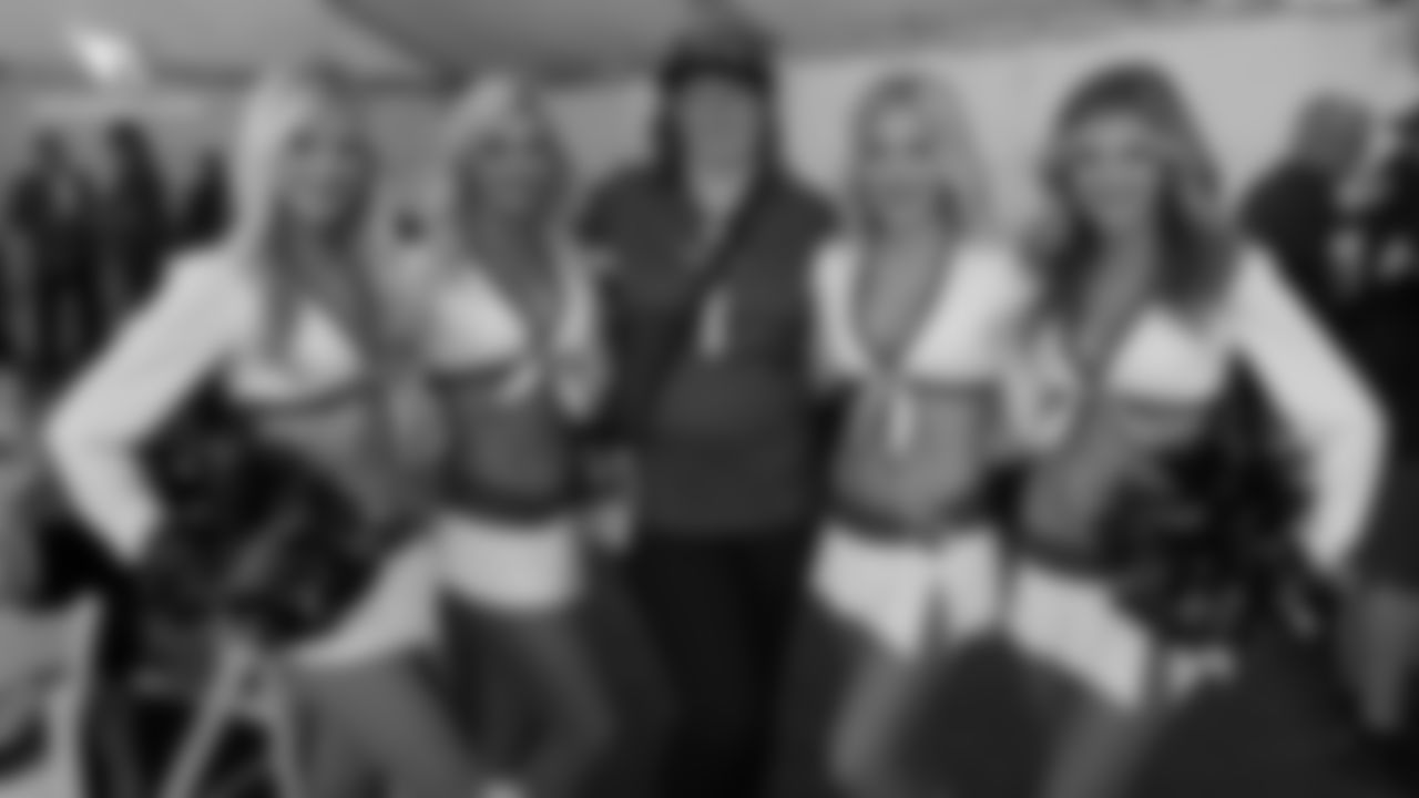 The Cardinals cheerleaders with a fan during the Cardinals' draft party outside State Farm Stadium last Thursday