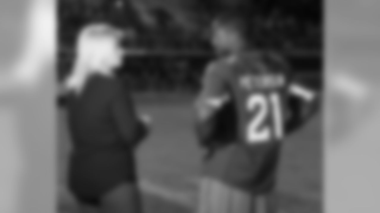 Nicole Bidwill and Patrick Peterson chat on the field at Red Mountain High School