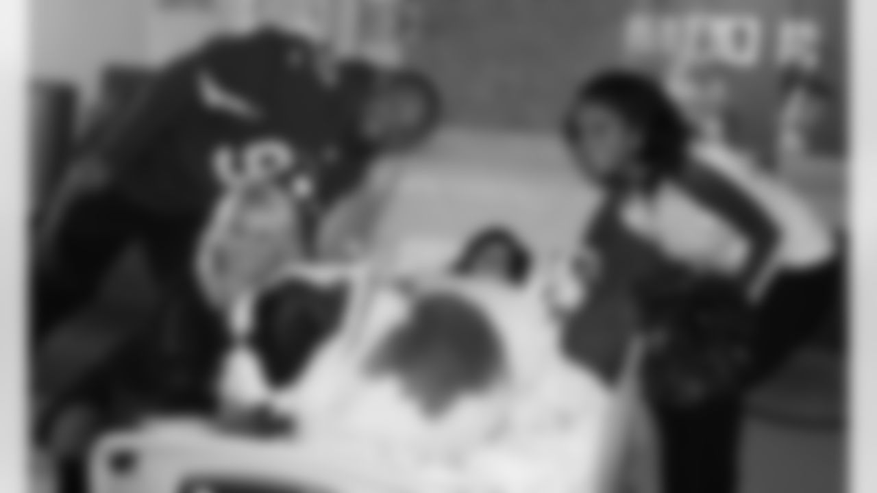 Nicole Bidwill's therapy dog, Barney, a 160-pound St. Bernard, plops down on a patient's bed.