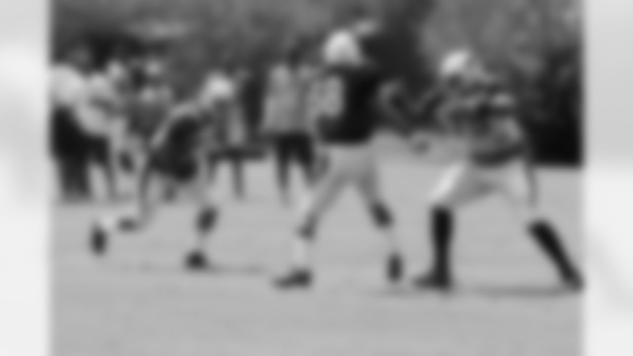 TE Rob Housler, after the catch, tries to avoid LB Daryl Washington as T Levi Brown comes to make the block