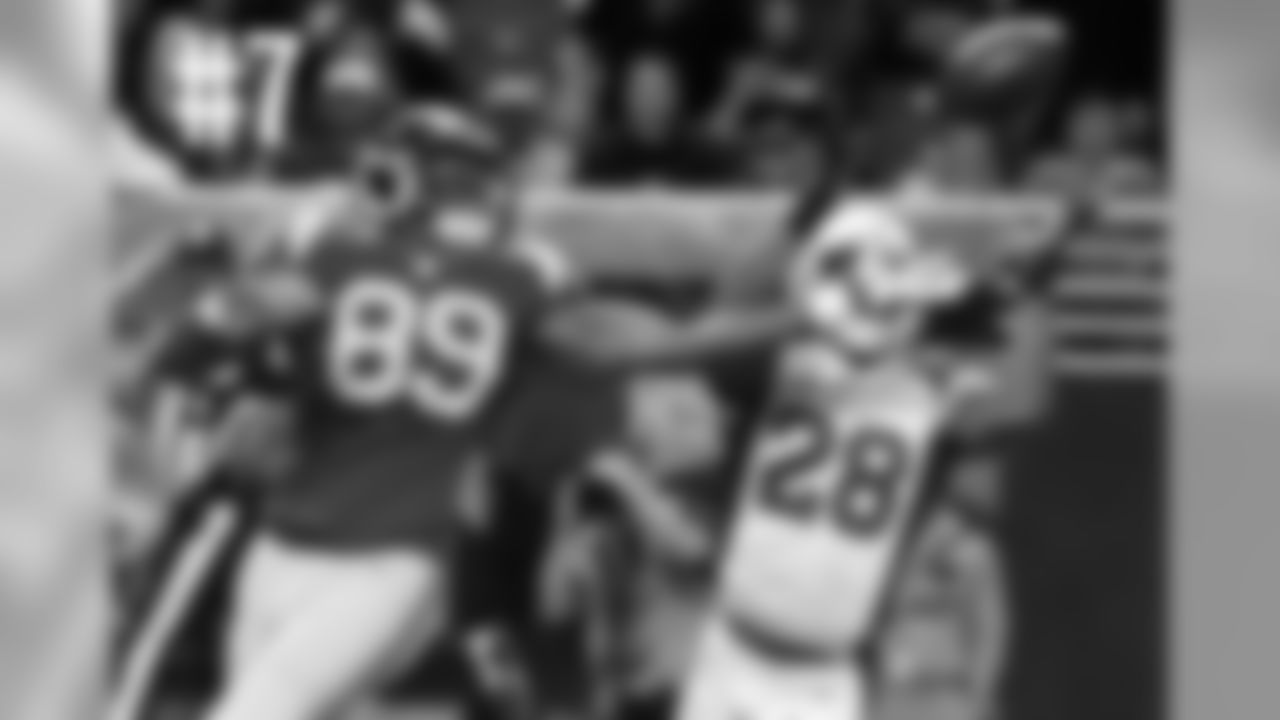 Rams TE Jared Cook breaks up an interception attempt by CB Justin Bethel