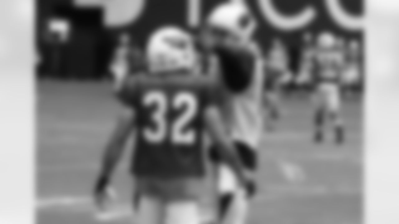 WR Jaron Brown and S Tyrann Mathieu "discuss" a play