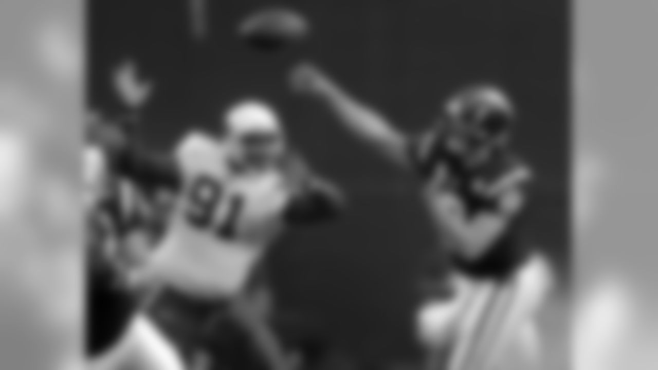 QB Drew Brees delivers a pass as Cardinals DE Wendell Bryant pressures him in 2003