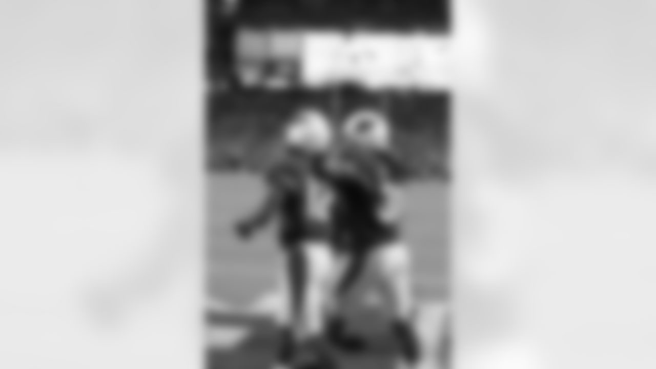 RB Andre Ellington (right) puts his arm around WR John Brown