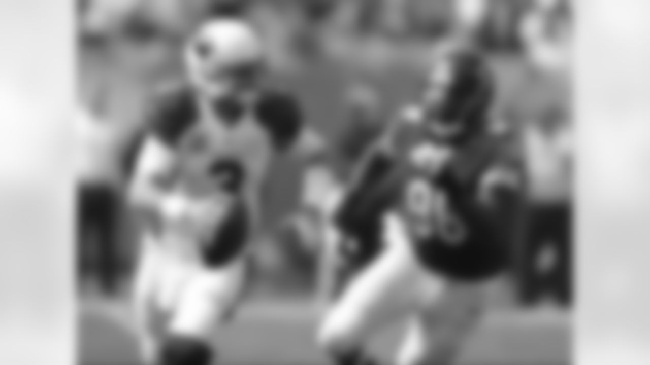 Arizona Cardinals quarterback Carson Palmer (3) scrambles away from Chicago Bears defensive tackle Jarvis Jenkins (96) during the first half of an NFL football game, Sunday, Sept. 20, 2015, in Chicago.