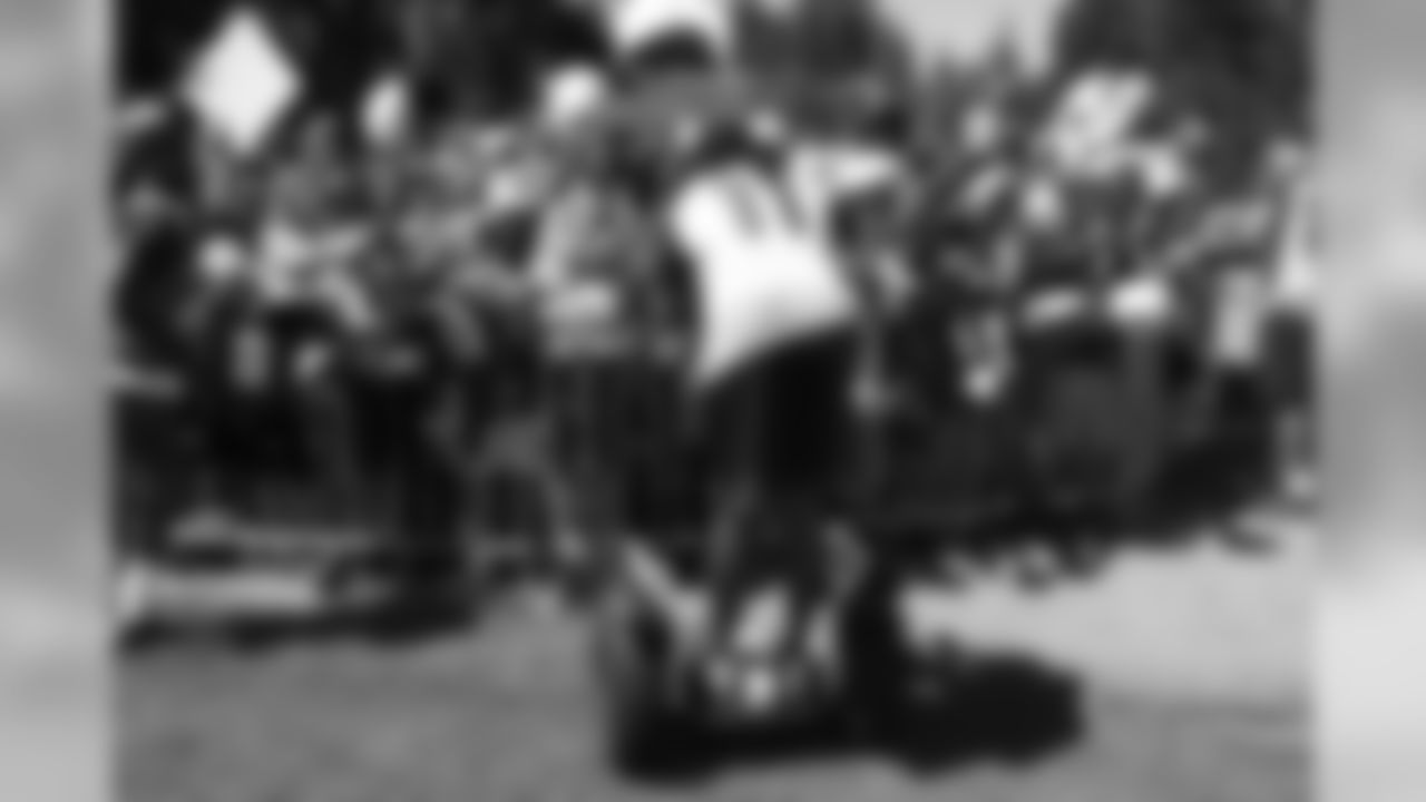 WR Larry Fitzgerald stands on a segway and signs autographs.