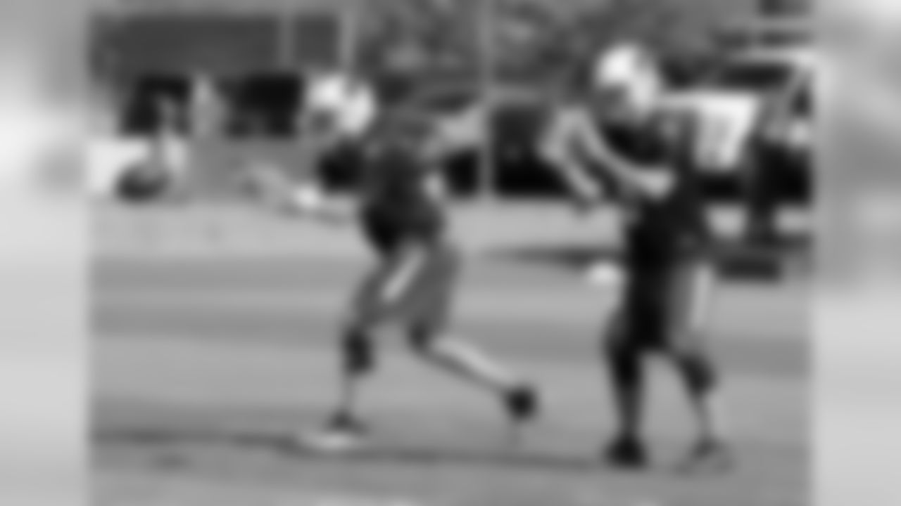 Quarterbacks Carson Palmer (left) and Drew Stanton catching snaps