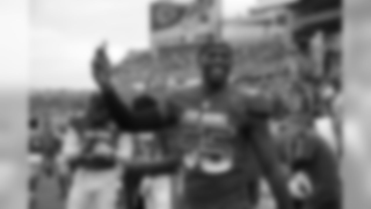 LB Chandler Jones records with his phone on the sideline