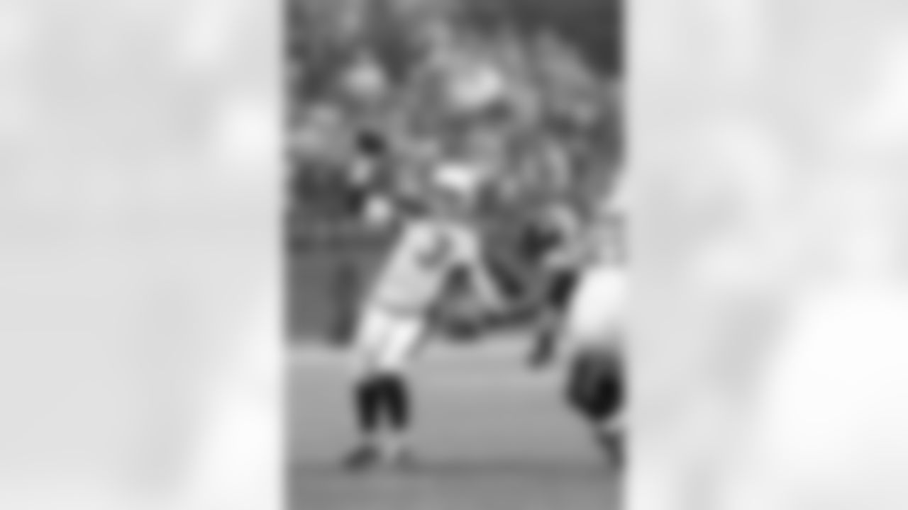 Week 16: QB Carson Palmer gets his jersey tugged as he throws a pass in Seattle.