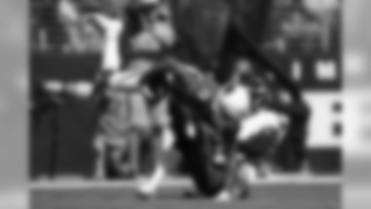 Arizona Cardinals wide receiver KeeSean Johnson, left, tries to break free from Baltimore Ravens cornerback Brandon Carr after making a catch.