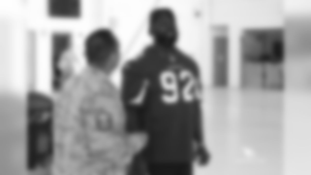 DL Frostee Rucker speaks with a military member