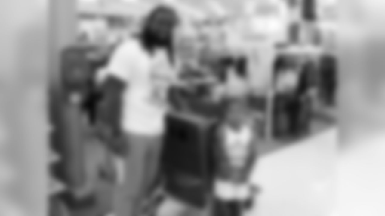 RB Robert Hughes with a young shopper