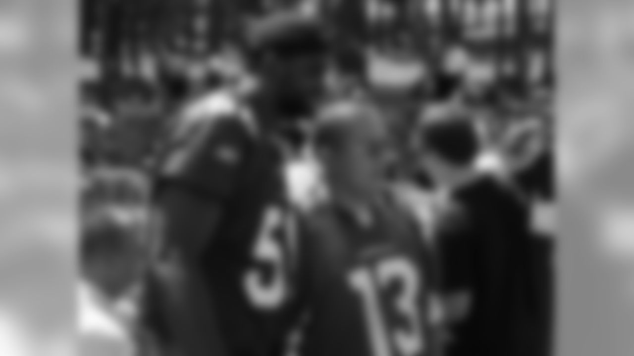 Karlos Dansby takes a photo with a fan
