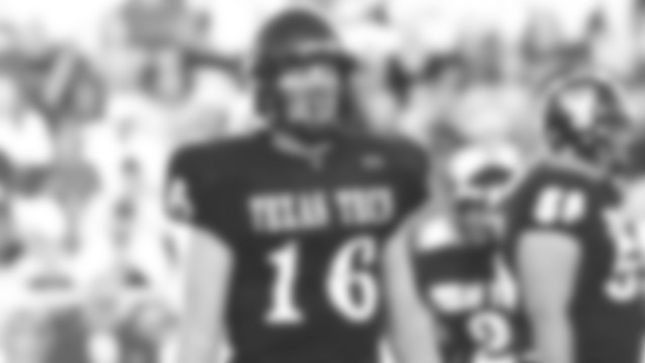 Texas Tech QB Kliff Kingsbury waits to get a play from the sideline.