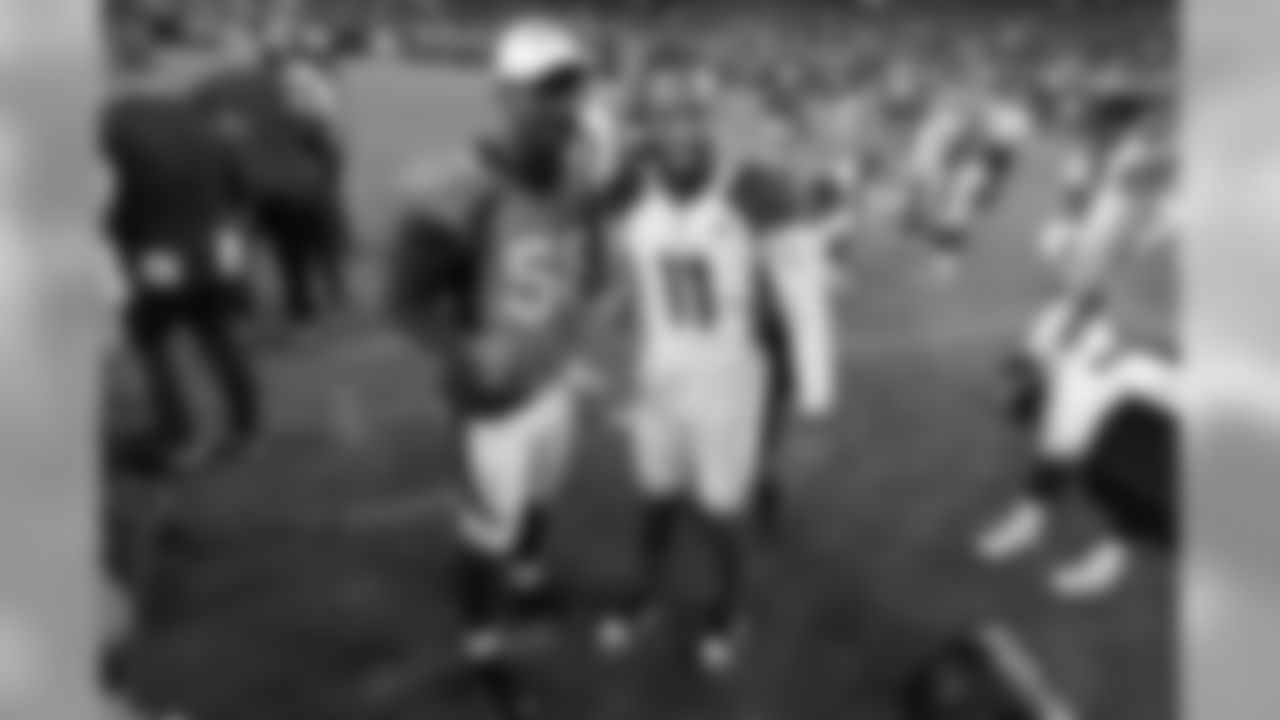Denver Broncos outside linebacker Von Miller (58) greets Arizona Cardinals wide receiver Larry Fitzgerald (11) after an NFL preseason football game in Denver.