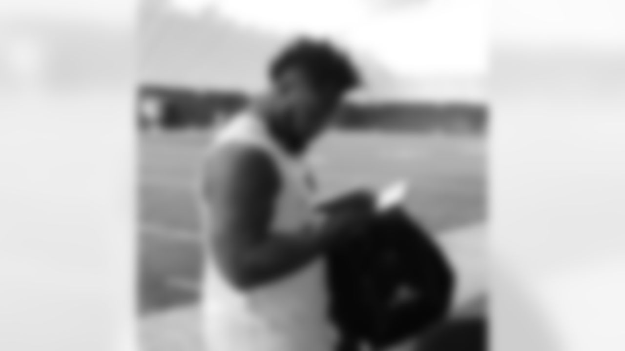 DT Darnell Dockett checks out the video games given to the players from the Madden group