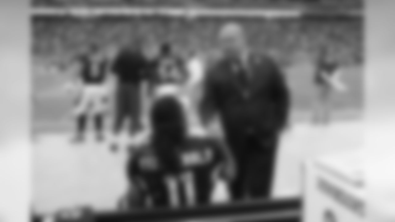 GM Steve Keim greets WR Larry Fitzgerald on the sidelines.