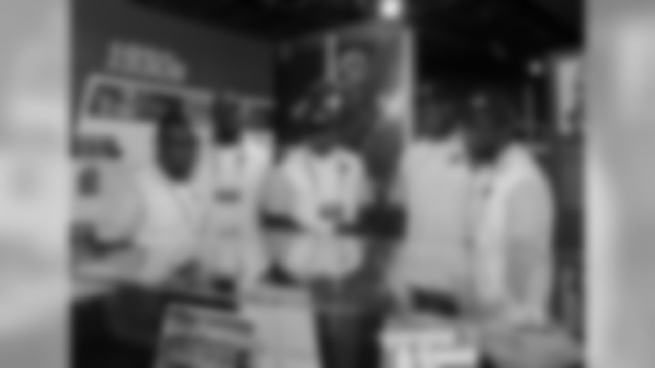 Senior director of player development Anthony Edwards guides Rodney Gunter, David Johnson, D.J. Humphries and J.J. Nelson through a Hall of Fame exhibit