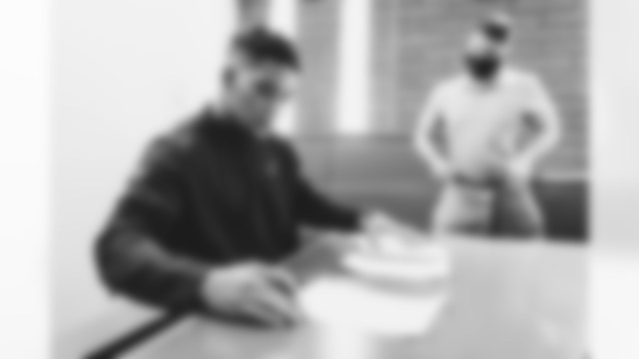Images of veteran running back James Conner signing his one-year contract on Tuesday.