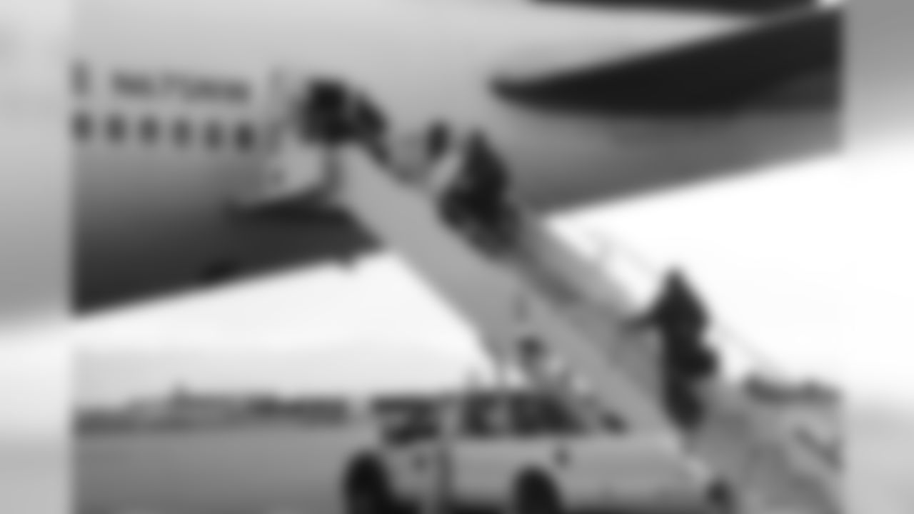 The players board the plane