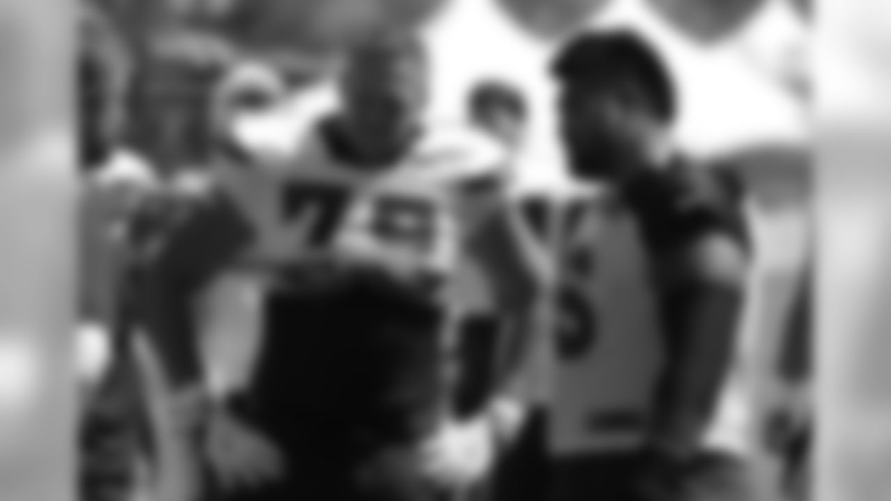 G Mike Iupati talks with Chargers T Kenny Wiggins