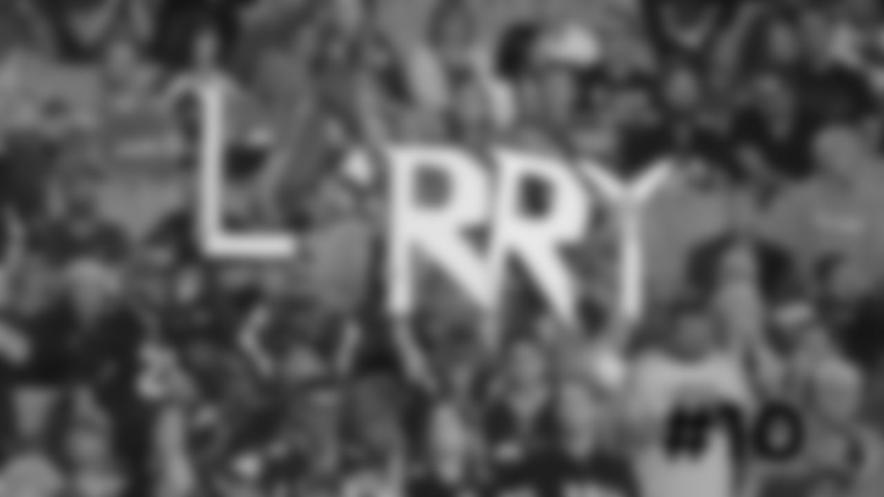 10. Cardinals fans hold up a sign for WR Larry Fitzgerald