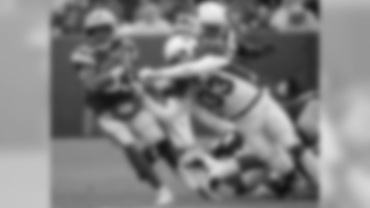 Green Bay Packers running back Aaron Jones is hit during a run by Arizona Cardinals defensive back Tre Boston during the second half of an NFL football game Sunday, Dec. 2, 2018, in Green Bay, Wis.