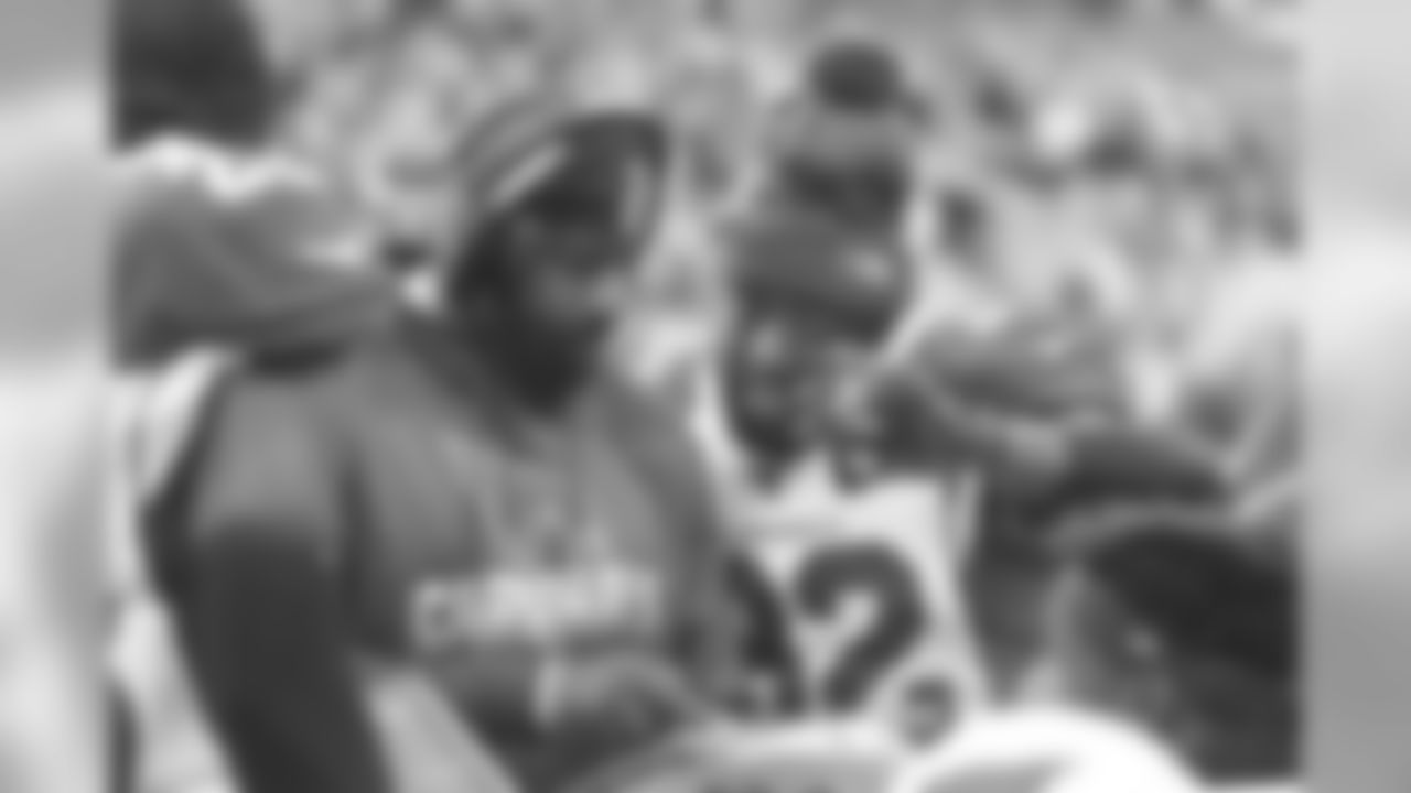 S Budda Baker goes over a play on the sideline.