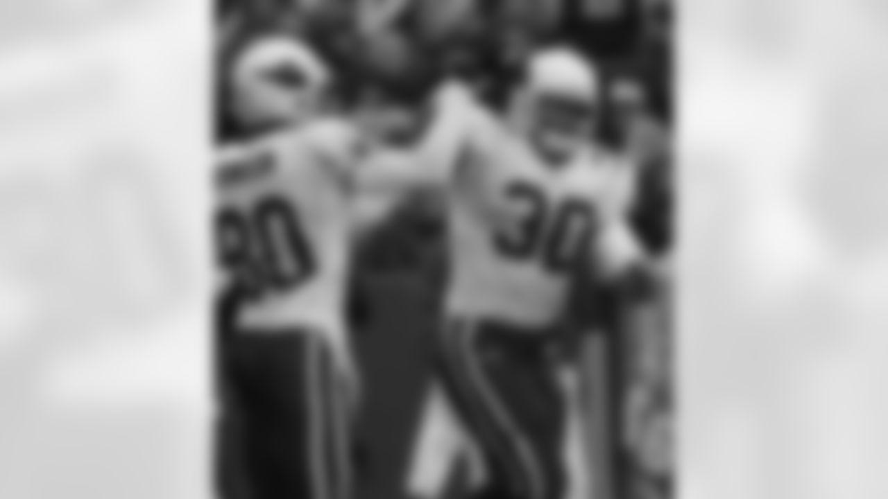 2004: Obafemi Ayanbadejo is congratulated by Bryant Johnson after scoring a touchdown