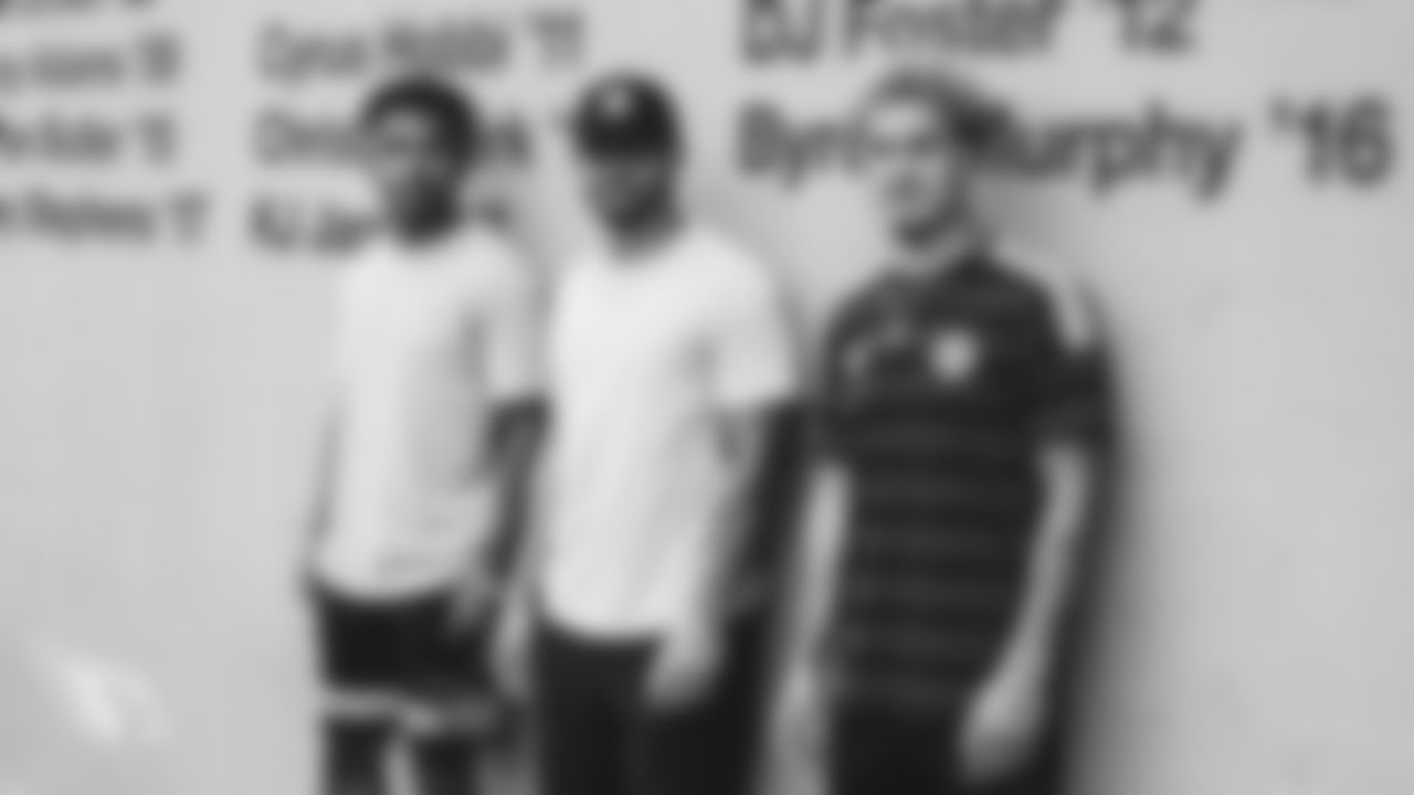 From left: WR Christian Kirk, RB D.J. Foster and CB Byron Murphy lean against Saguaro's All-American wall