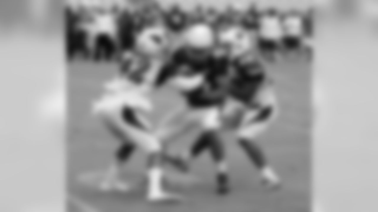 CB Damond Smith (42) and S Harold Jones-Quartey (23) tackle WR Trevor Harman