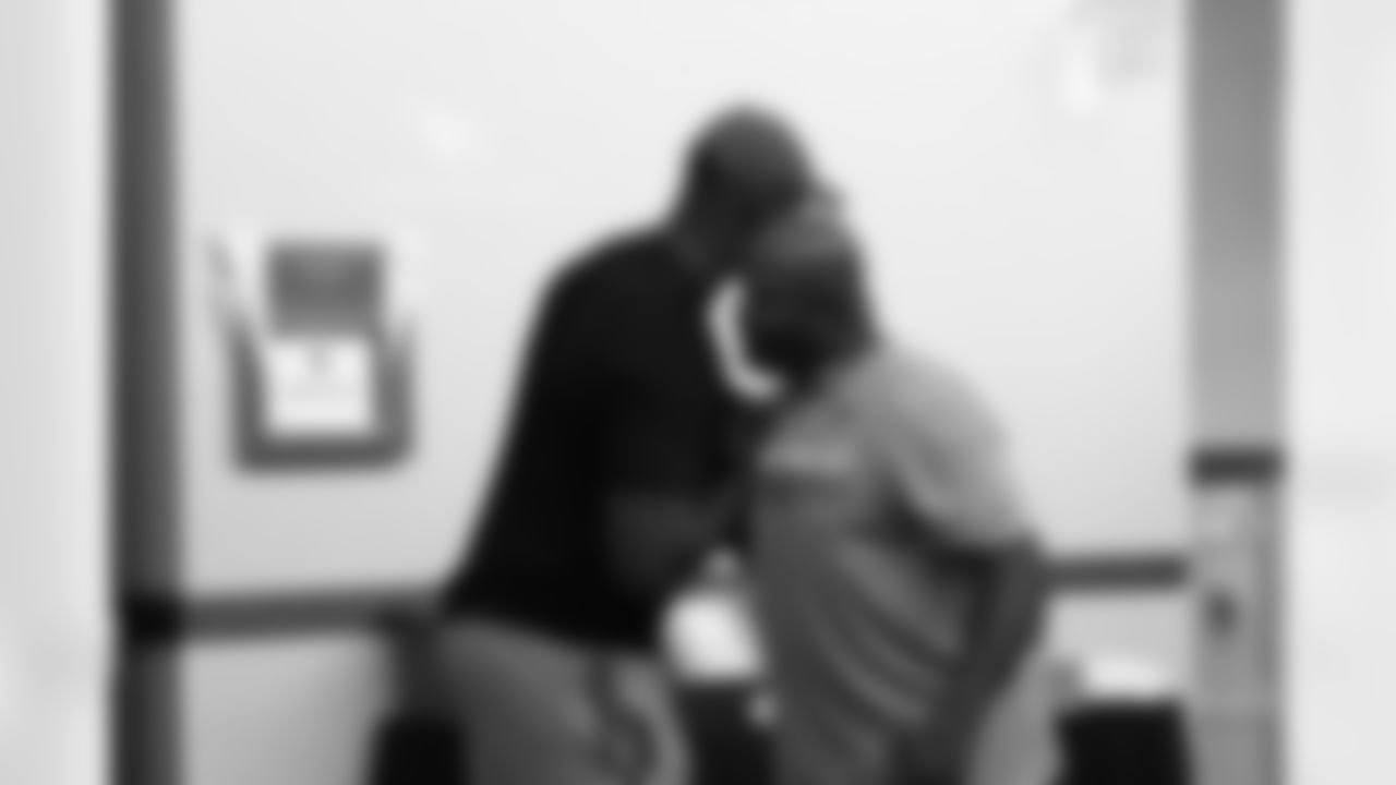 LB Chander Jones (left) greets cornerbacks coach Kevin Ross
