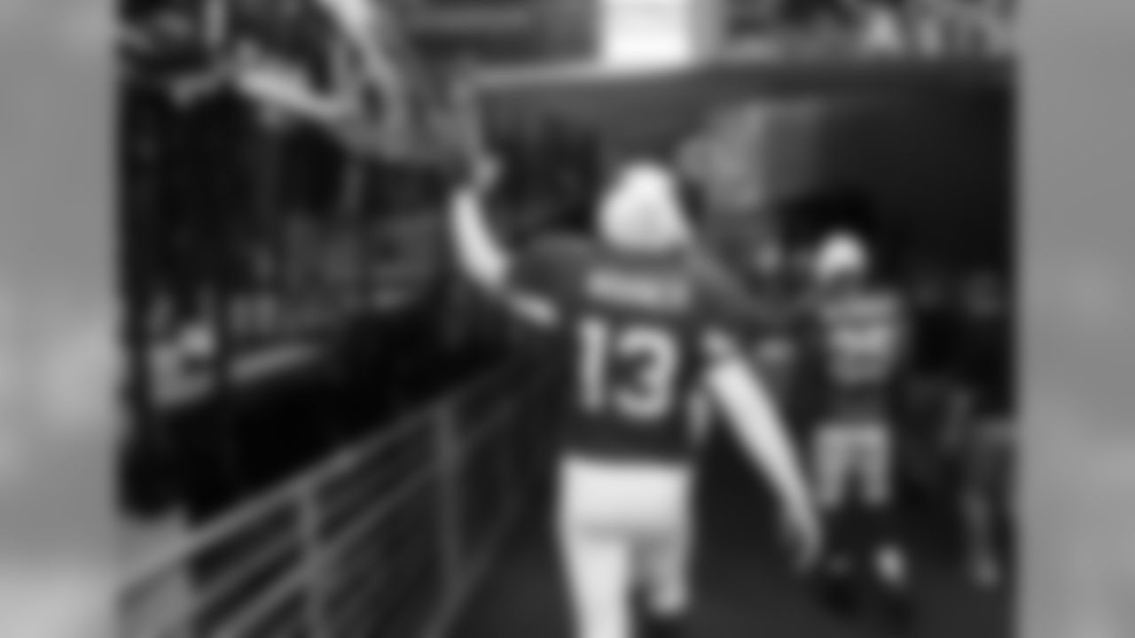 Warner slapping the hands of fans after the wild card win over the Packers in 2010