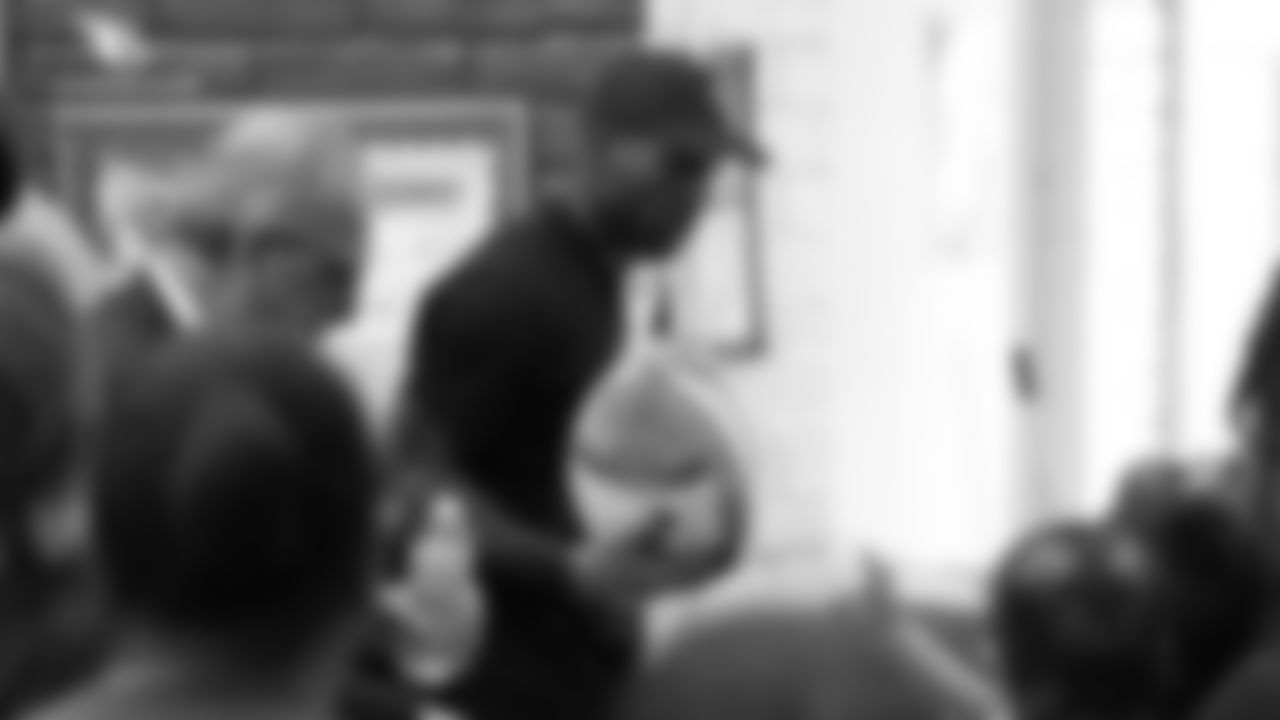 CB Patrick Peterson hands a turkey to a family