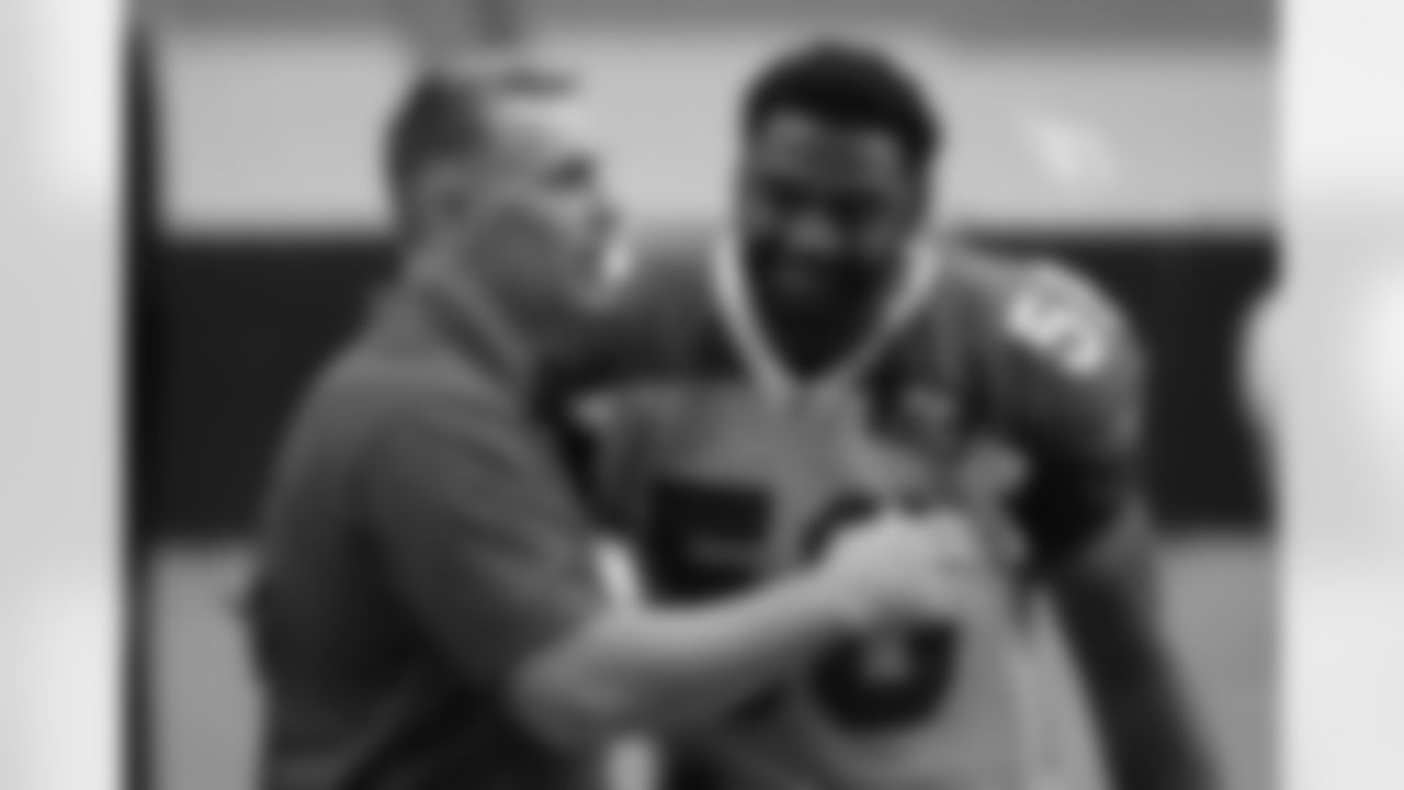 Day 12: Hall of Fame quarterback Kurt Warner (left) hugs LB Karlos Dansby