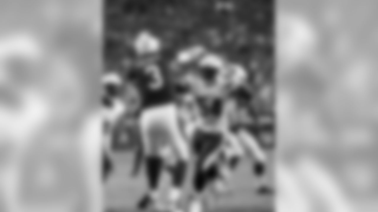 QB Carson Palmer gets rid of the ball as the pass-rush bears down