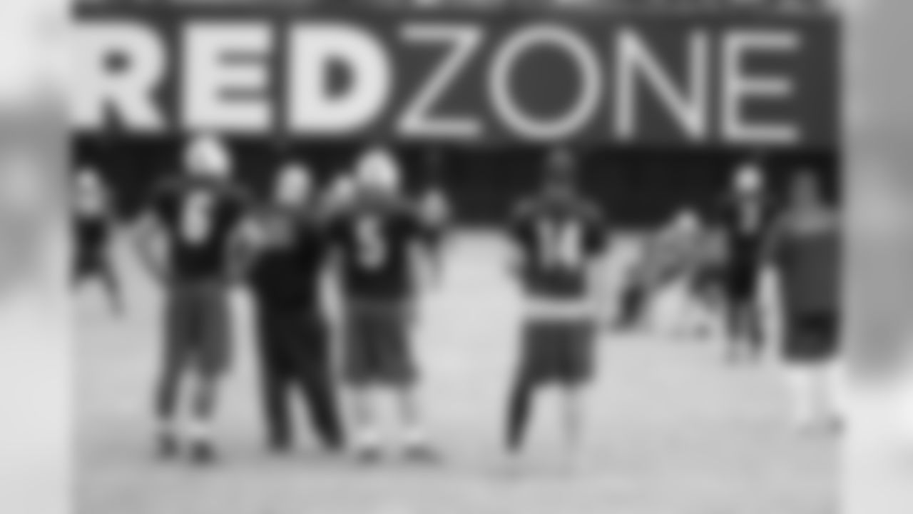 The quarterbacks watch the action