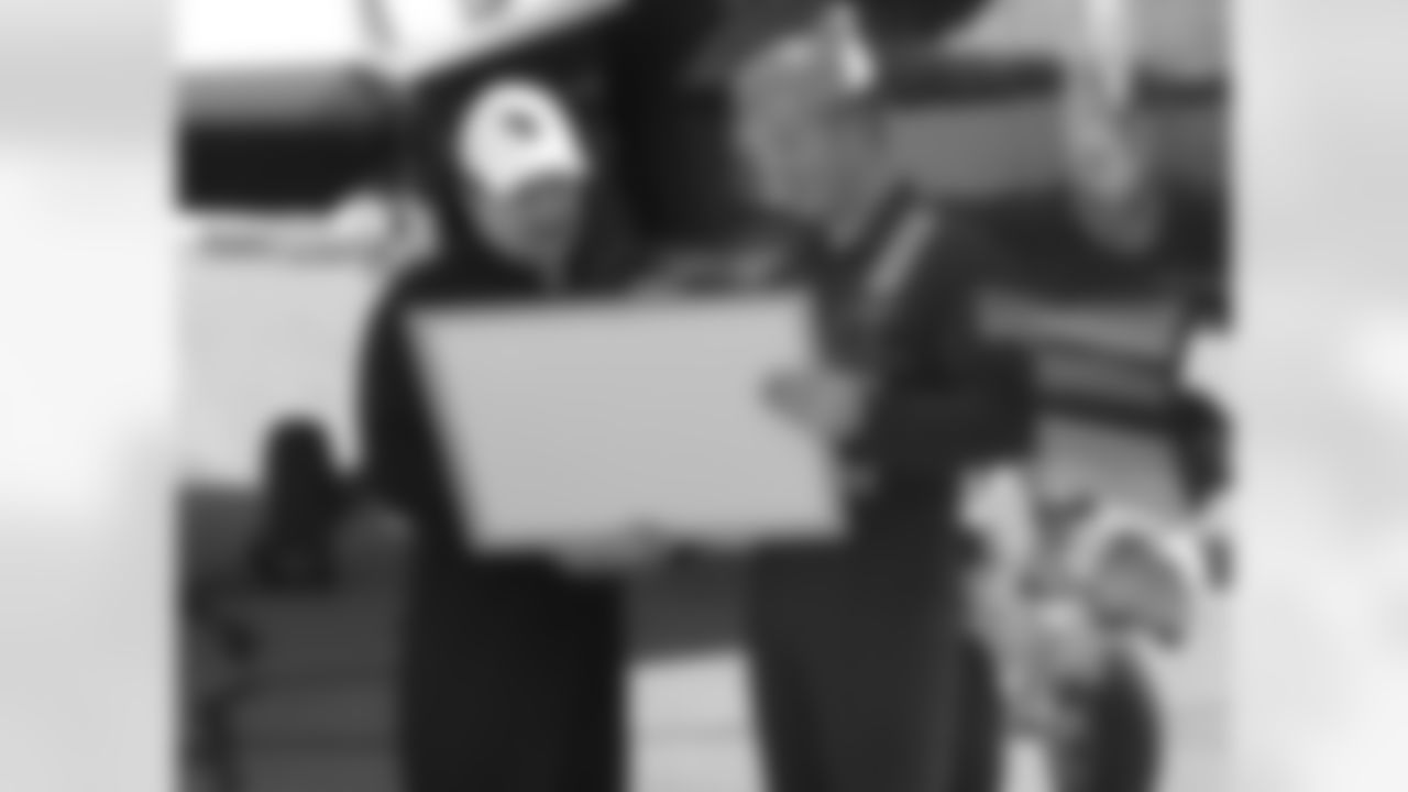 Lt. Frank Weisser presents Bidwill with an autographed Blue Angels photogra