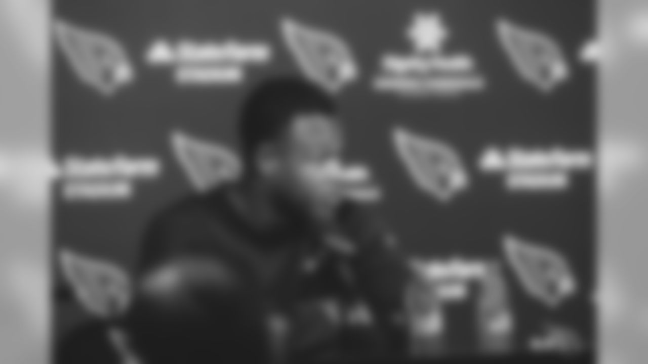 Images of T D.J. Humphries signing his three-year contract extension with the Cardinals and then meeting with the media