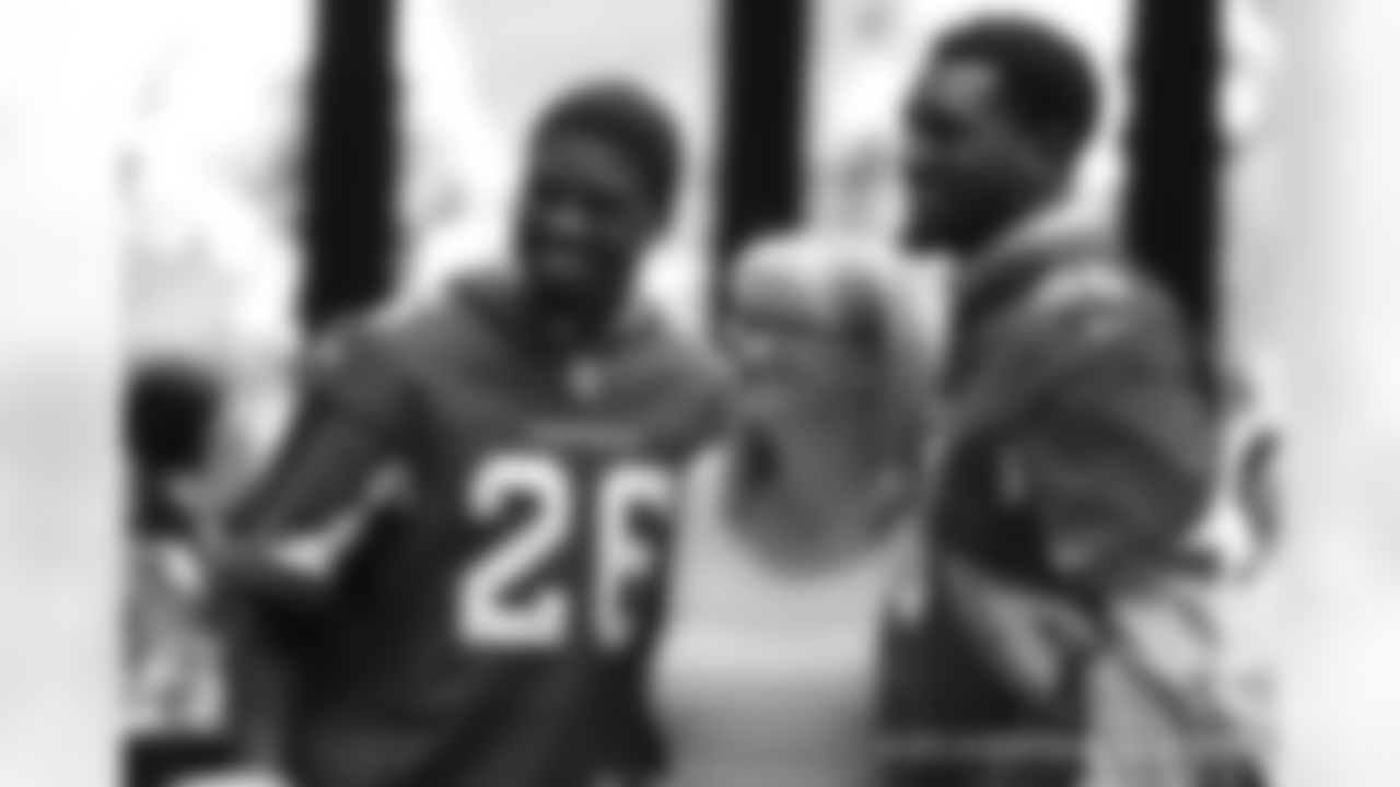 CB Brandon Williams (left) and LB Gabe Martin pose for a photo with a fan