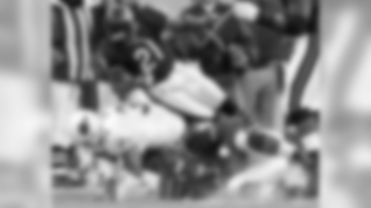 Chicago Bears' Alex Brown, bottom right, tucks in the ball as he recovers a fumble by Arizona Cardinals quarterback Jeff Blake as Cardinals' Marcel Shipp, left, and Bears' R.W. McQuarters fall to the ground in the fourth quarter Sunday, Nov. 30, 2003, in Chicago. The Bears won, 28-3.