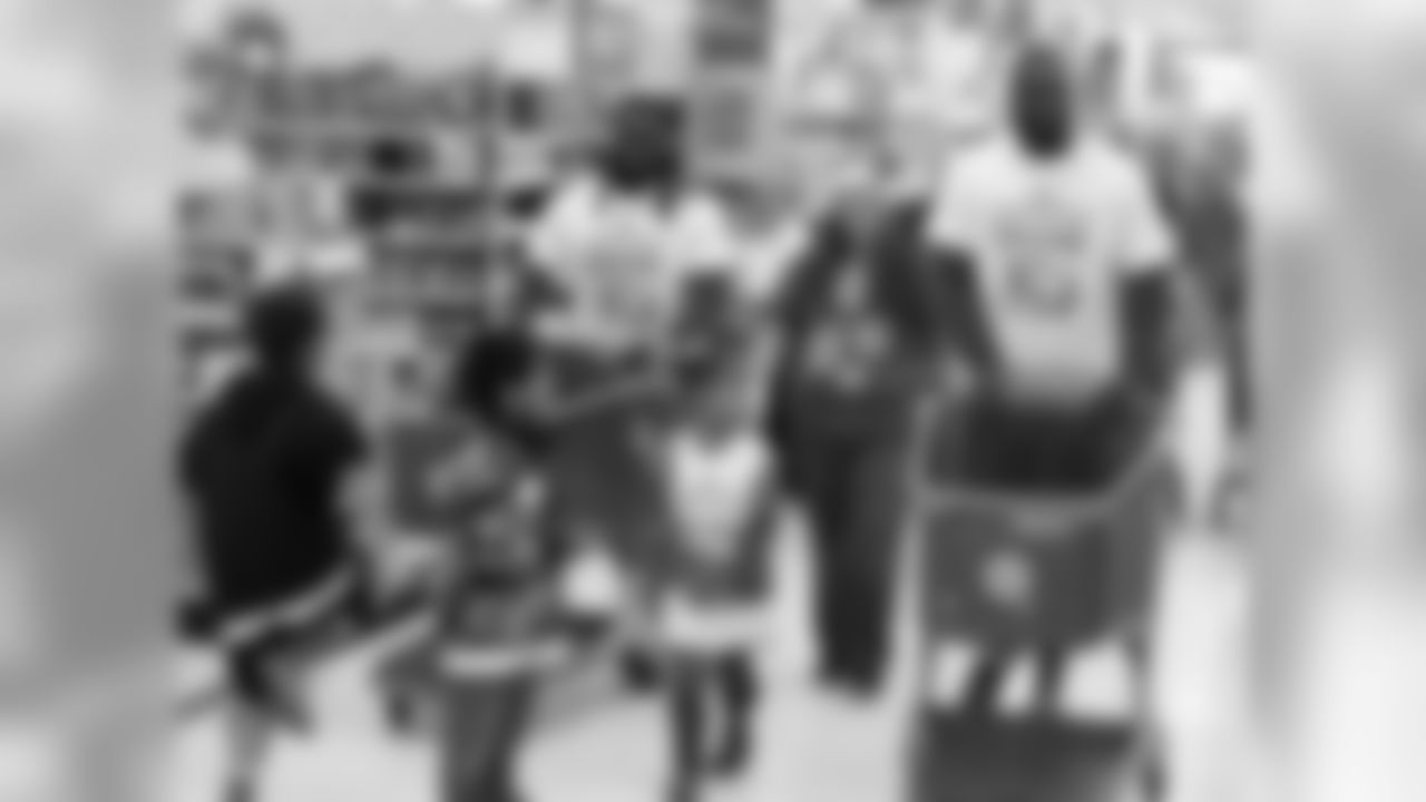 RB Robert Hughes (left), LB Alex Okafor (right) and their shoppers