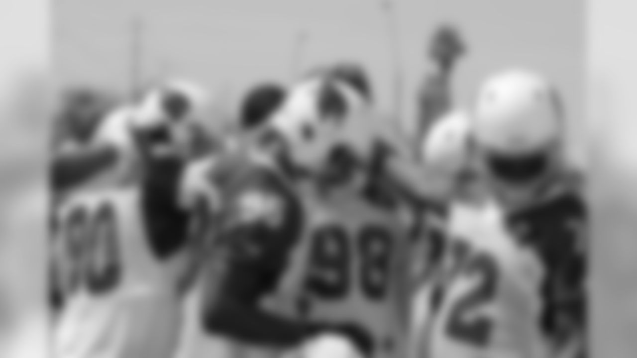The defensive line huddles before position drills