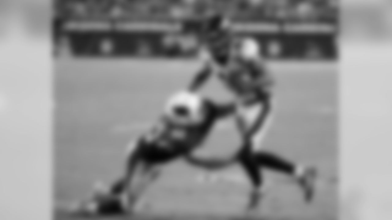 Broncos wide receiver Mark Chapman is tackled by Cardinals linebacker Dennis Gardeck.