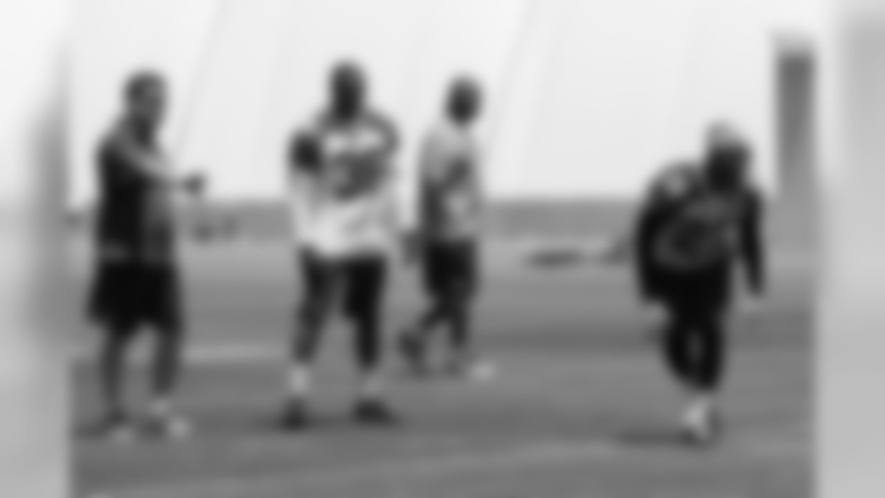 Defensive backs coach Nick Rapone (left) helps Deone Bucannon (36) shadow strong safety Tony Jefferson (22)