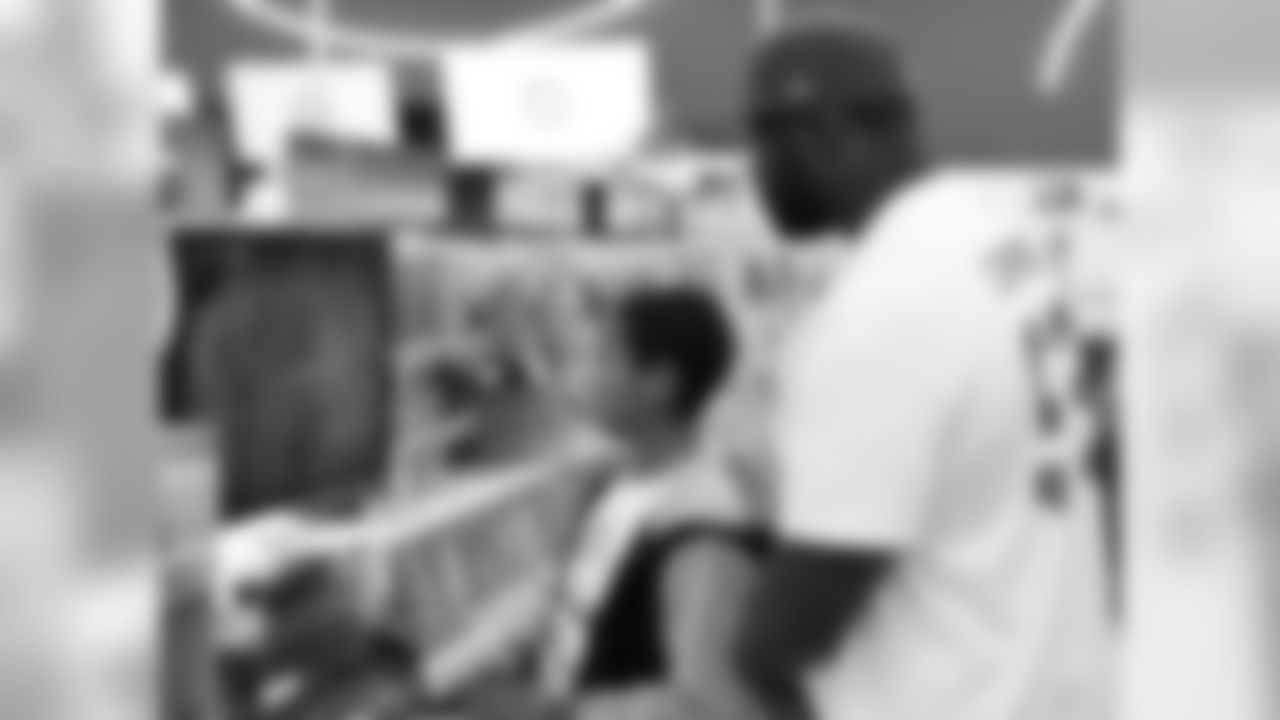DT Frostee Rucker and his shopper checking out a video game