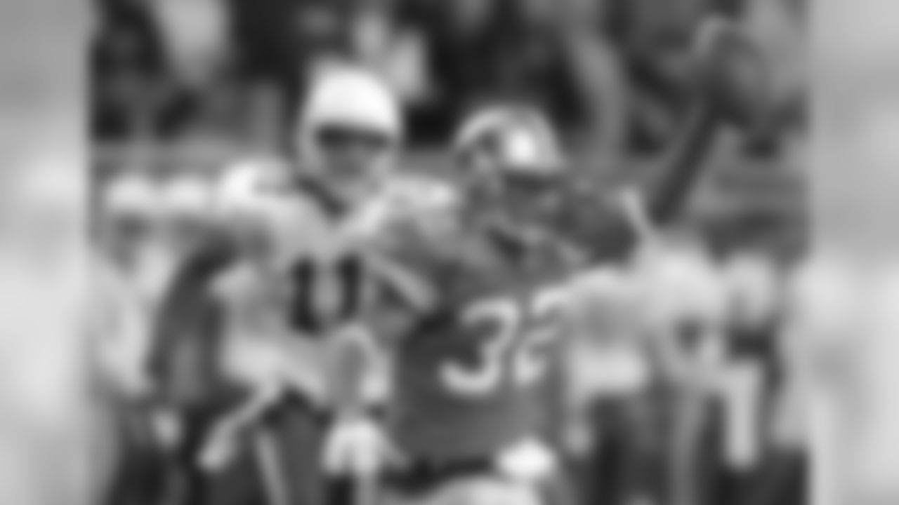 Detroit Lions cornerback Dre Bly (32) holds up the ball after intercepting the pass intended for Arizona Cardinals receiver Larry Fitzgerald (11) in the third quarter at Ford Field in Detroit, Sunday, Dec. 5, 2004. Bly had two interceptions for the Lions in their 26-12 win.