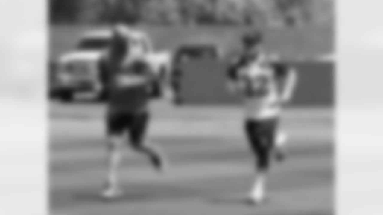 Tyrann Mathieu jogs with assistant athletic trainer Chad Cook