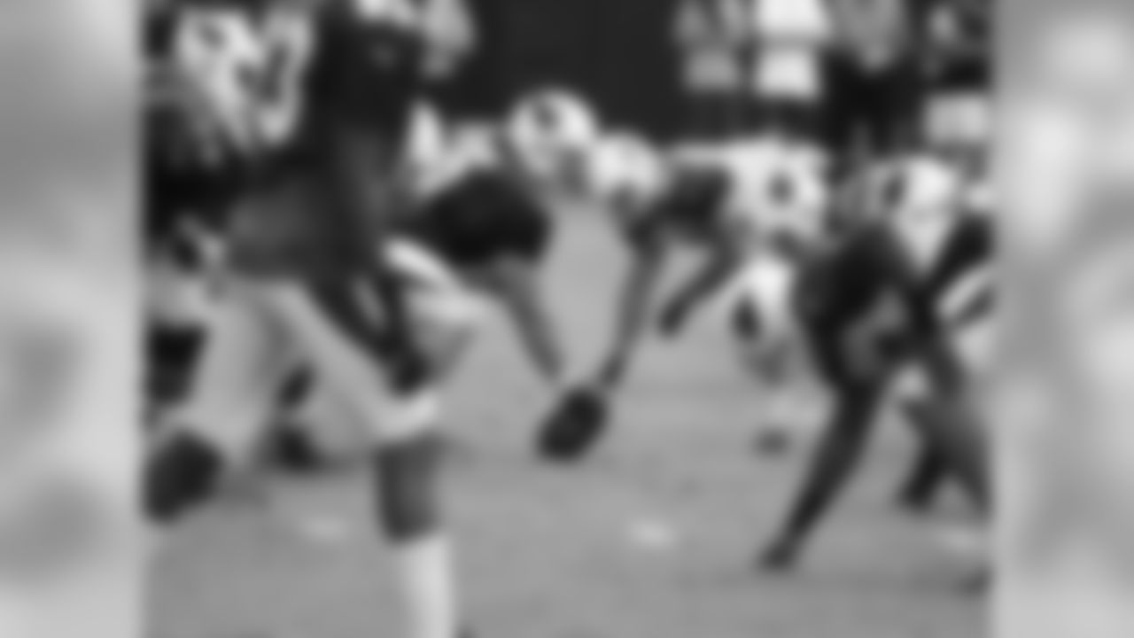 C John Estes prepares to snap the ball