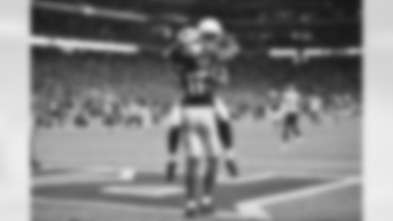 WR John Brown hugs WR Larry Fitzgerald